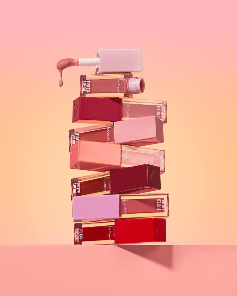Trending vegan cosmetics including lip gloss, lip oil, lipstick, and eyebrow products for cruelty-free beauty market.