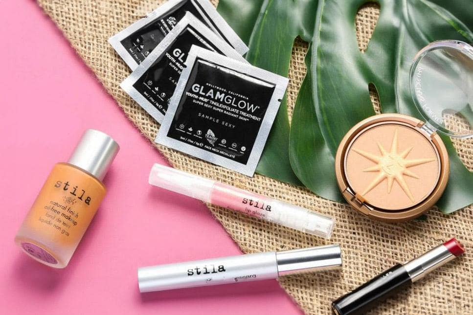 Cosmetic sample testing process showing beauty product evaluation including lip gloss, foundation, and eyebrow makeup samples.